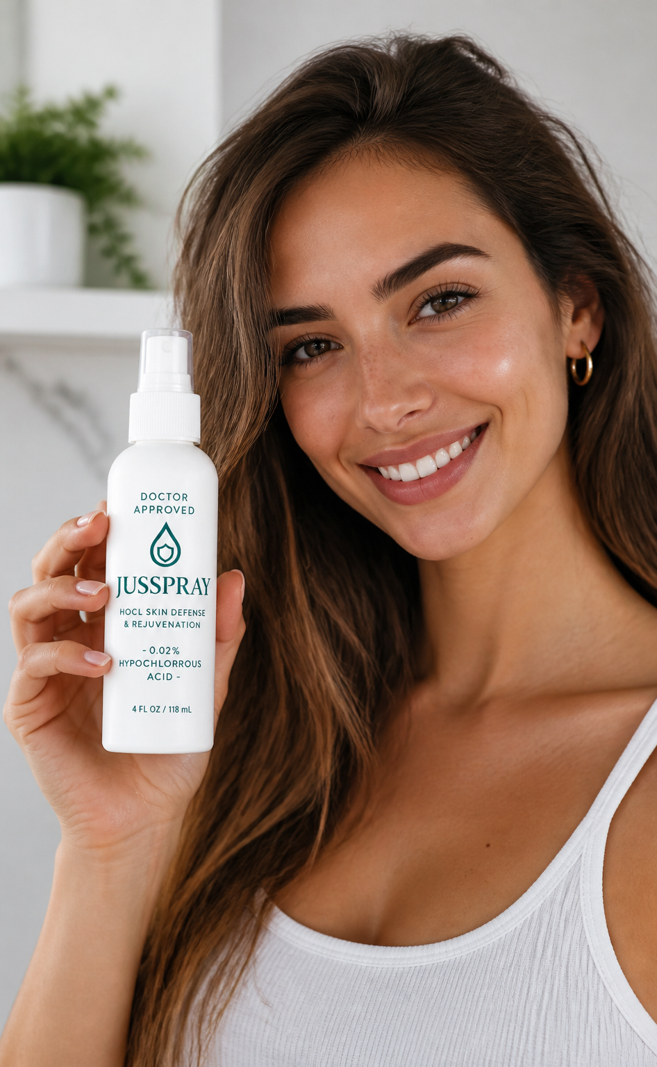Woman holding the JusSpray HOCl Face and Body Spray beside her face